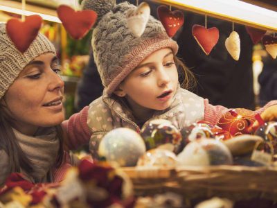 mother and daughter selecting decoration on a Christmas market